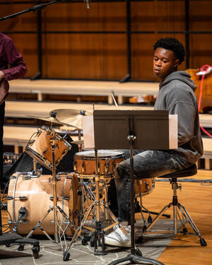 A student drumming during a jazz performance